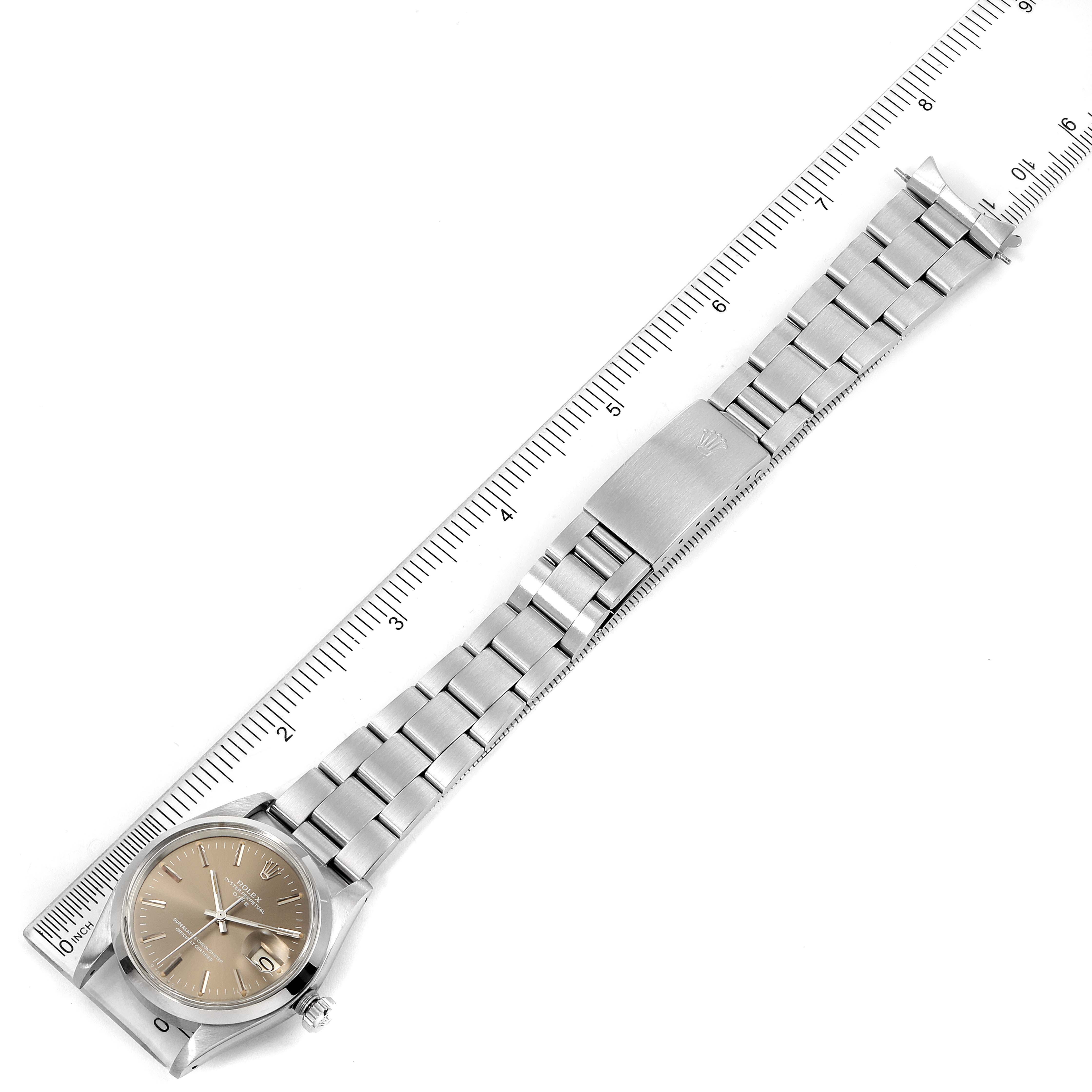 The image shows a top-down view of a Rolex Vintage Collection 1500 Men's Stainless Steel Grey Dial 1500 Men's Stainless Steel Grey Dial watch with a silver band and ruler for scale.