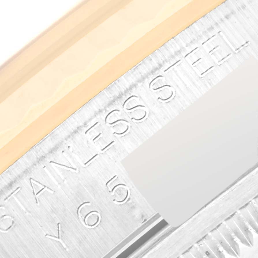 This close-up shows the engraving on the case back edge of a Rolex Datejust 16233 Men's Steel and Gold (two tone) Champagne Dial 16233 Men's Steel and Gold (two tone) Champagne Dial watch, highlighting the "STAINLESS STEEL" text.