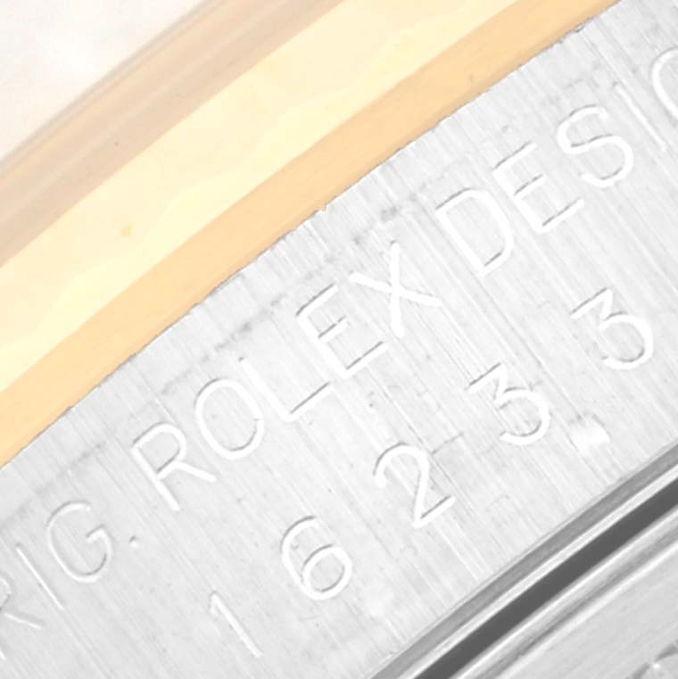 This close-up image shows the engravings on the side of the casing of a Rolex Datejust 16233 Men's Steel and Gold (two tone) Champagne Dial 16233 Men's Steel and Gold (two tone) Champagne Dial watch.