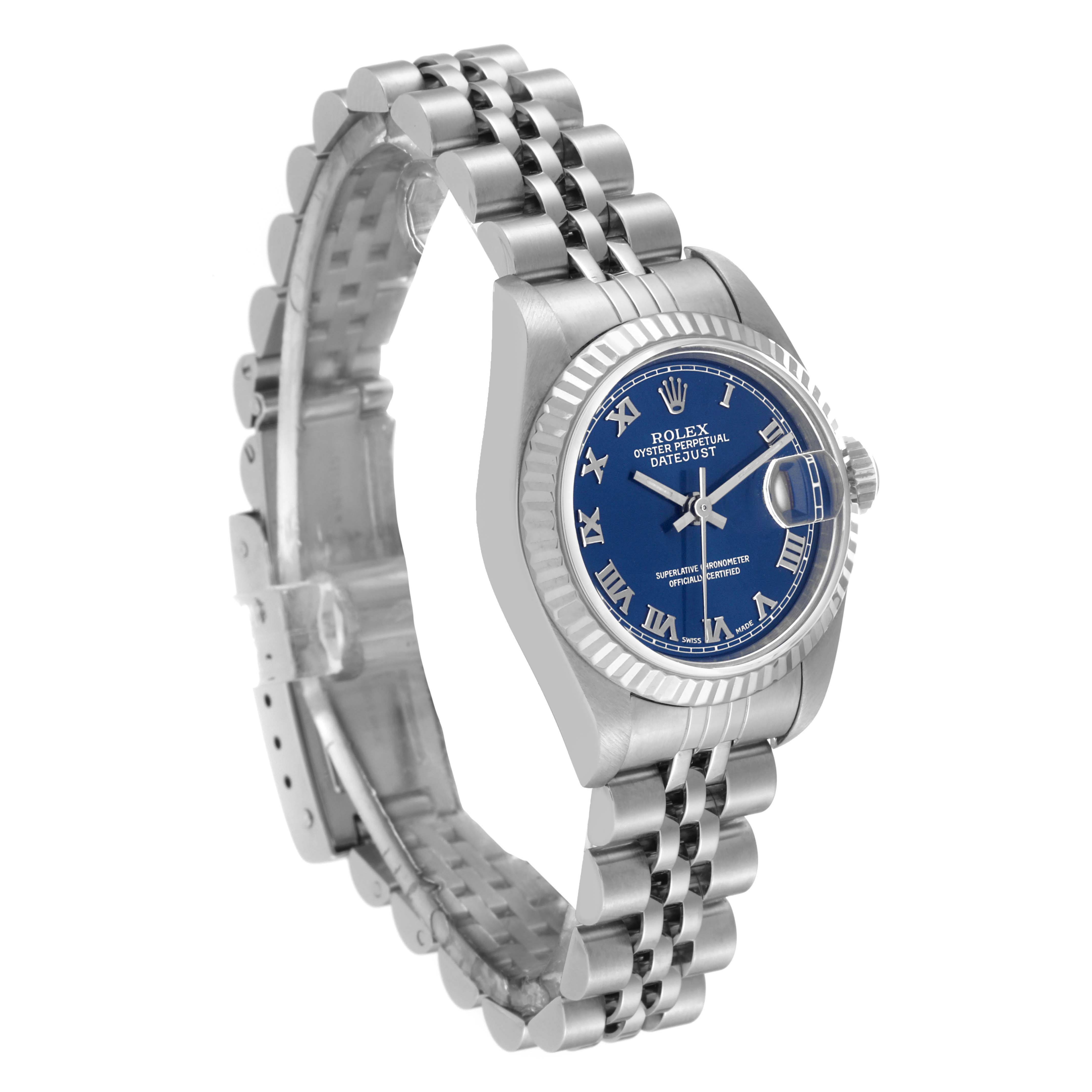The image shows a Rolex Datejust 79174 Women's Stainless Steel Blue Dial 79174 Women's Stainless Steel Blue Dial watch at a three-quarter angle, highlighting its blue dial, fluted bezel, and jubilee bracelet.