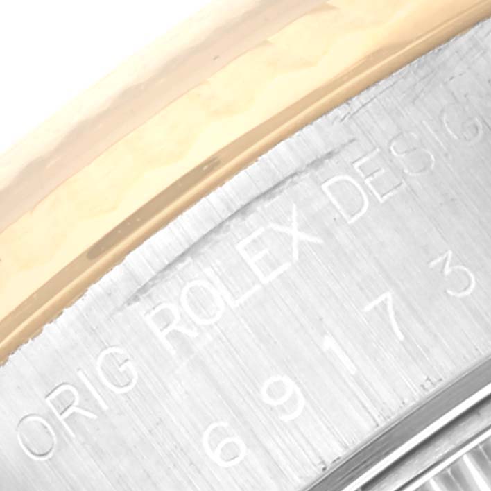 The image shows an angled close-up of the engraved bezel on a Rolex Datejust 69173 Women's Steel and Gold (two tone) Grey Dial 69173 Women's Steel and Gold (two tone) Grey Dial watch.