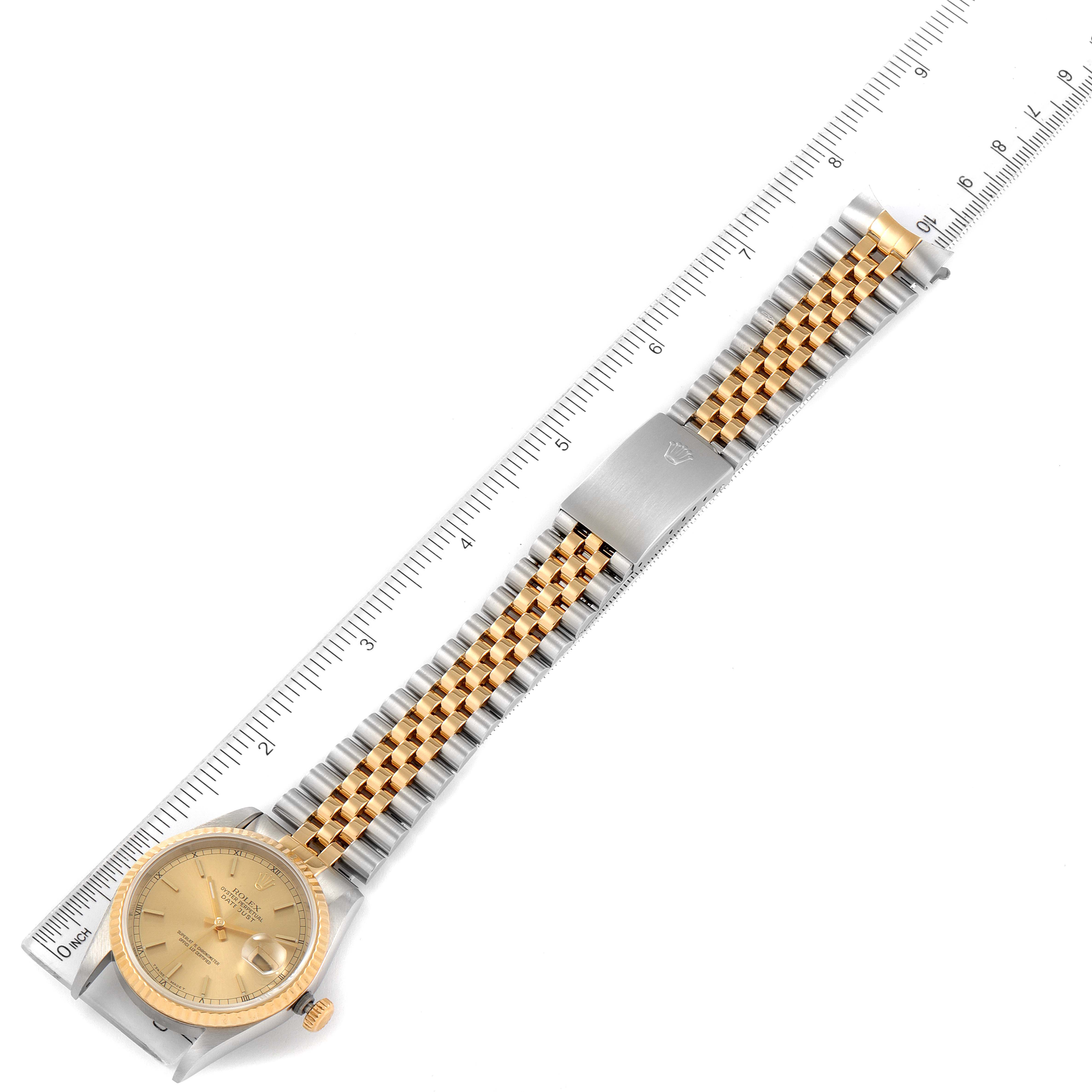 The image shows a top-down view of a Rolex Datejust 16233 Men's Steel and Gold (two tone) Champagne Dial 16233 Men's Steel and Gold (two tone) Champagne Dial watch, including the face, bracelet, and clasp, beside a ruler for scale.