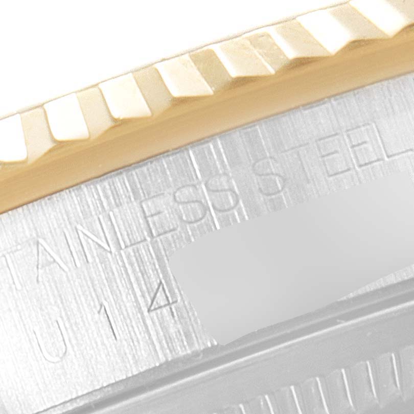 The image shows a close-up of the bezel and part of the case of a Rolex Datejust 16233 Men's Steel and Gold (two tone) Champagne Dial 16233 Men's Steel and Gold (two tone) Champagne Dial watch.