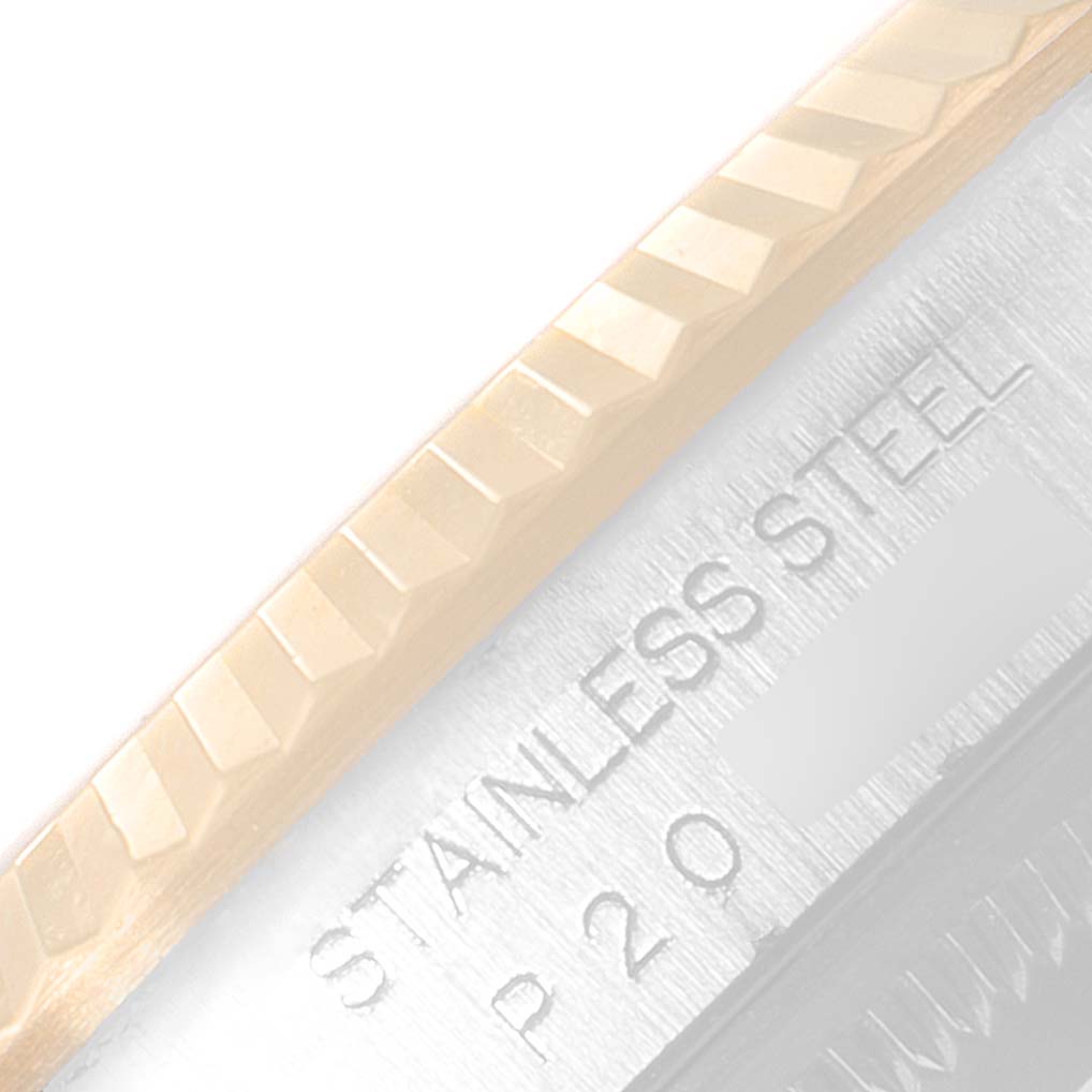 The image shows a close-up of the side of a stainless steel bezel and the fluted edge of a Rolex Datejust 16233 Men's Steel and Gold (two tone) Black Dial 16233 Men's Steel and Gold (two tone) Black Dial watch.