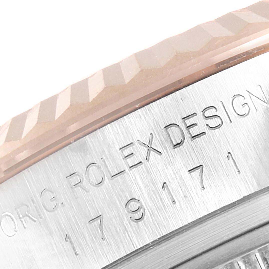 This close-up image shows the fluted bezel and part of the case with engravings on a Rolex Datejust 179171 Women's Steel and Gold (two tone) Black Dial 179171 Women's Steel and Gold (two tone) Black Dial watch.