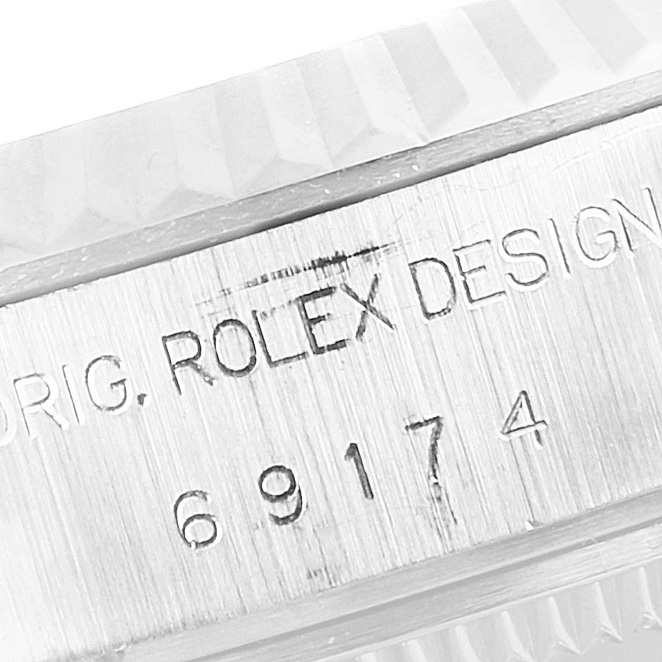 This image shows a close-up of the engraved model number and Rolex inscription on the case of a Rolex Datejust 69174 Women's Stainless Steel Silver Dial 69174 Women's Stainless Steel Silver Dial watch.