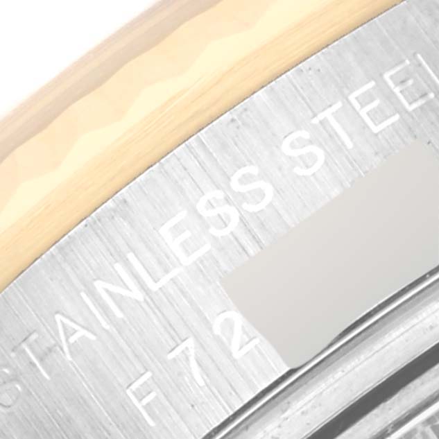 The image shows a close-up of the case's edge of a Rolex Datejust 179173 Women's Steel and Gold (two tone) Black Dial 179173 Women's Steel and Gold (two tone) Black Dial, highlighting "STAINLESS STEEL" engraving.