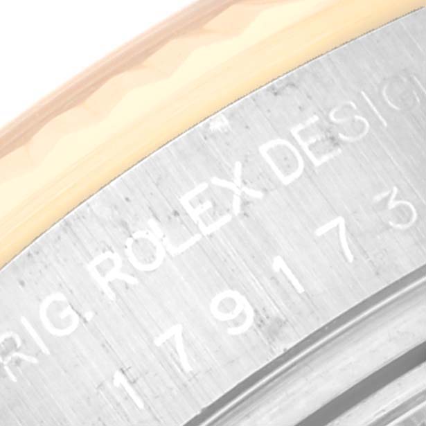 This close-up image shows the engraved text and part of the bezel of a Rolex Datejust 179173 Women's Steel and Gold (two tone) Black Dial 179173 Women's Steel and Gold (two tone) Black Dial watch.