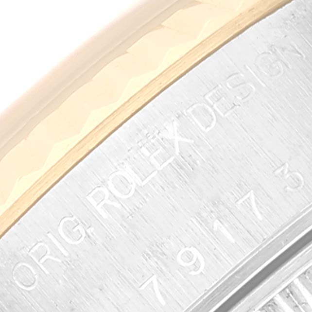 The image shows a close-up of the engraved case edge from the Rolex Datejust 79173 Women's Steel and Gold (two tone) Blue Dial 79173 Women's Steel and Gold (two tone) Blue Dial model.