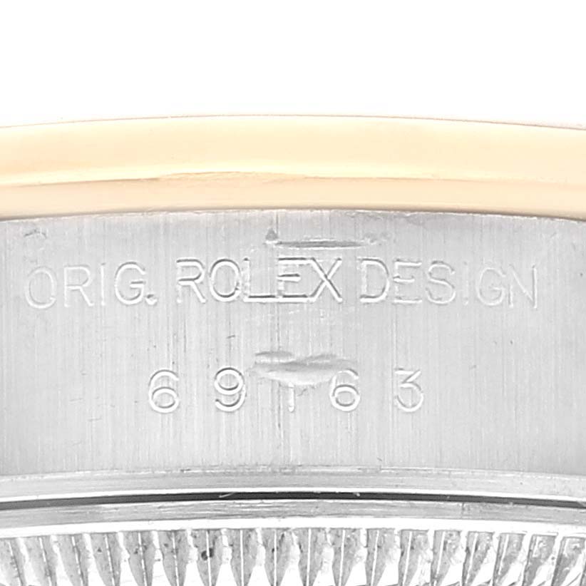 The image shows a close-up of the Rolex Datejust 69163 Women's Steel and Gold (two tone) White Dial 69163 Women's Steel and Gold (two tone) White Dial watch's case with the engraving "ORIG. ROLEX DESIGN" and model number.
