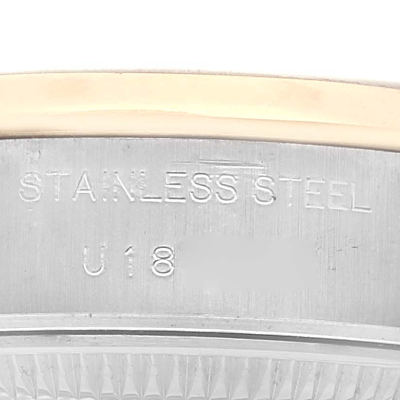 Close-up of the edge and casing of a Rolex Datejust 69163 Women's Steel and Gold (two tone) White Dial 69163 Women's Steel and Gold (two tone) White Dial watch showing the "STAINLESS STEEL" engraving.