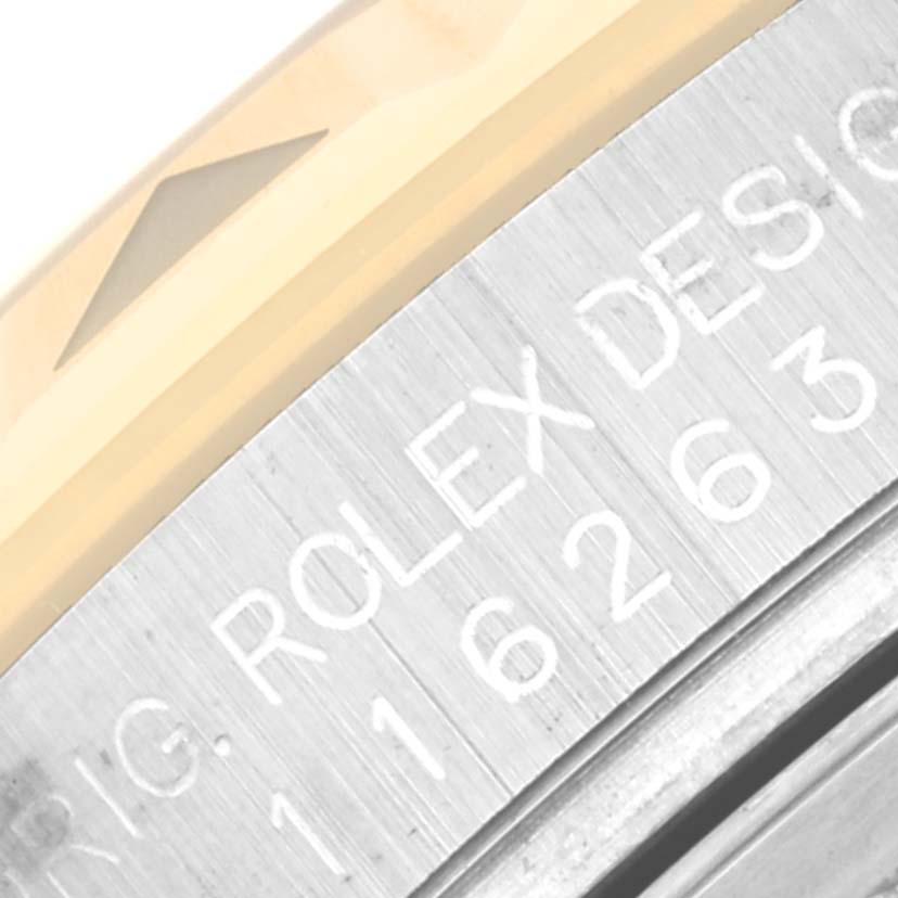 This image shows a close-up of the engraved side of a Rolex Turn-o-Graph 116263 Men's Steel and Gold (two tone) Champagne Dial 116263 Men's Steel and Gold (two tone) Champagne Dial watch bezel and casing.