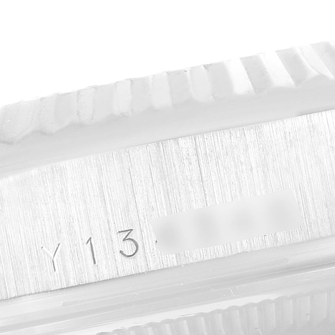 This close-up image shows the engraved serial number on the side of the President model by Rolex.