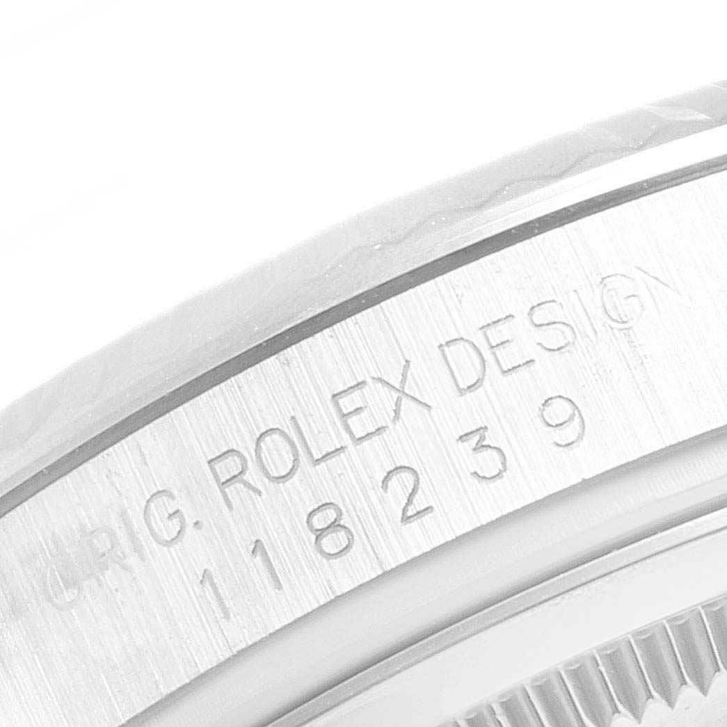 The image shows a close-up of the engraved bezel on a Rolex President 118239 Men
s White Gold Silver Dial 118239 Men
s White Gold Silver Dial model watch.