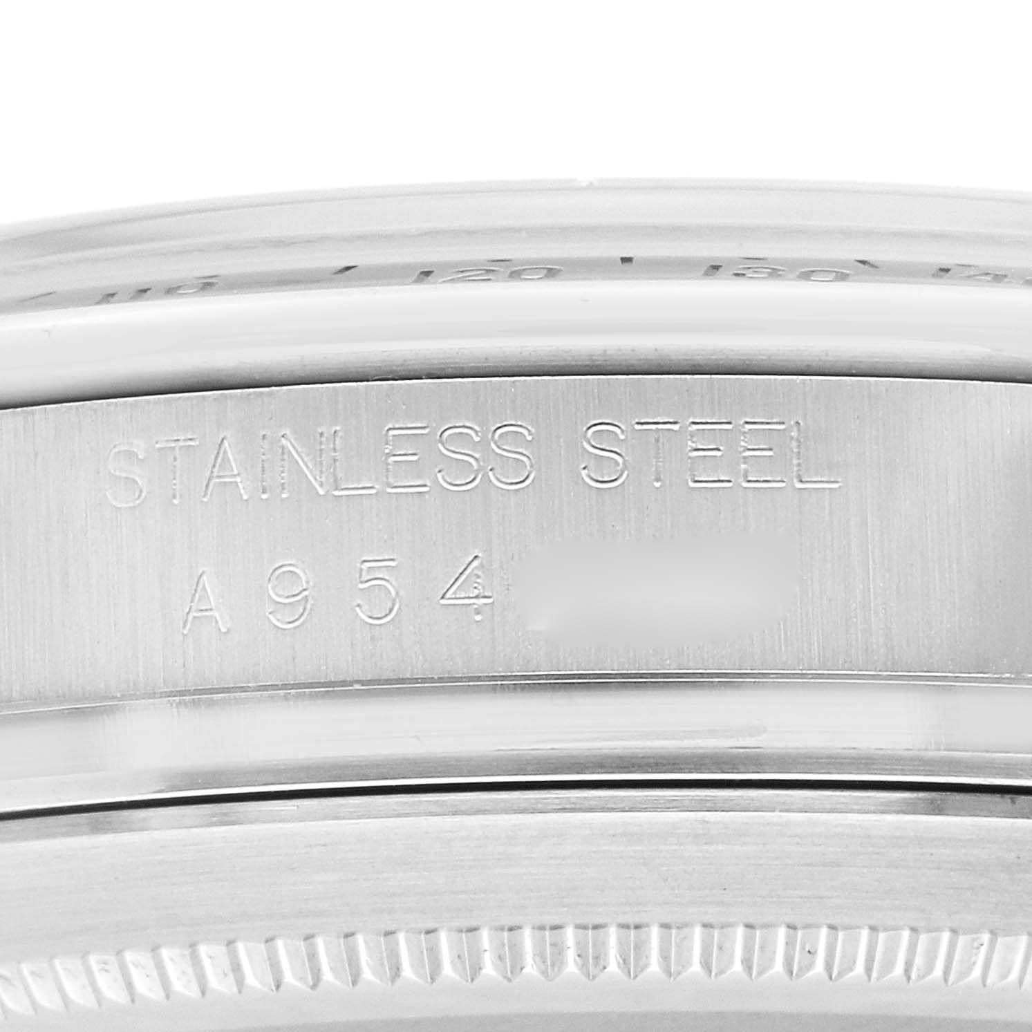 The image shows a close-up of the side of a stainless steel Rolex Daytona 16520 Men's Stainless Steel White Dial 16520 Men's Stainless Steel White Dial watch case with engraved text and partial view of the bezel.