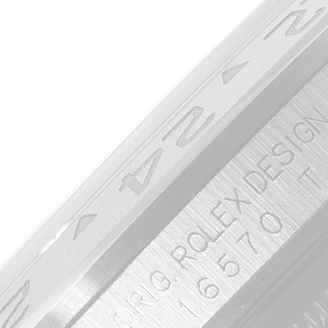 The image shows a close-up of the bezel and engraved design details of a Rolex Explorer 16570 Men's Stainless Steel White Dial 16570 Men's Stainless Steel White Dial watch.
