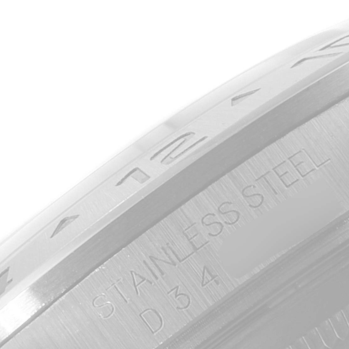 This image shows a close-up view of the side of the bezel and casing of a Rolex Explorer 16570 Men's Stainless Steel White Dial 16570 Men's Stainless Steel White Dial model watch, with "STAINLESS STEEL" engraving.
