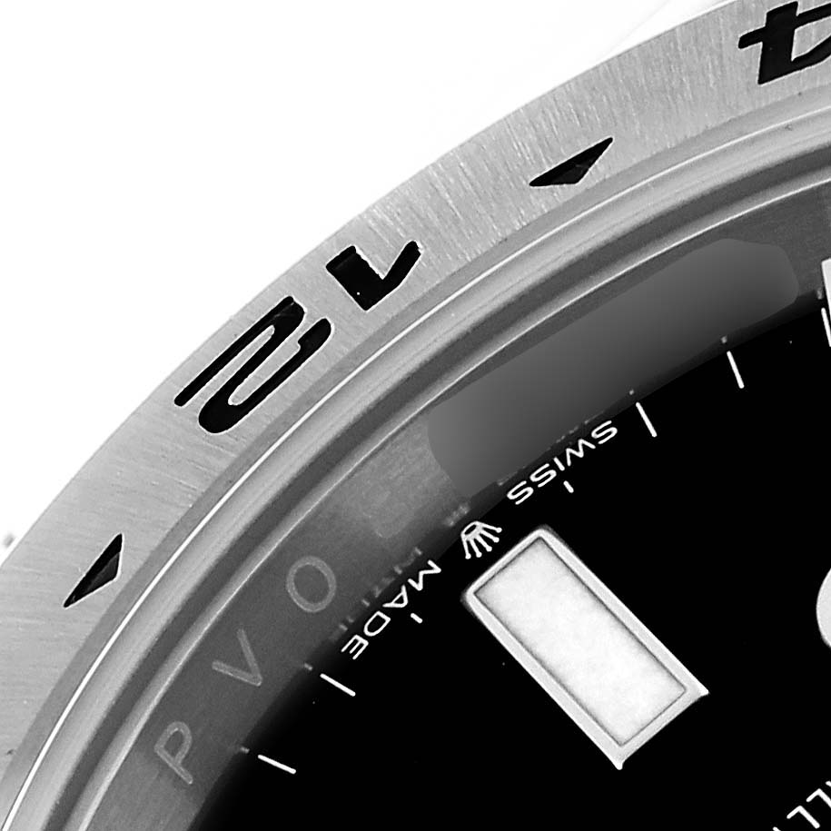 This close-up image of the Rolex Explorer 226570 Men
s Stainless Steel Black Dial 226570 Men
s Stainless Steel Black Dial model showcases the bezel and part of the watch dial.