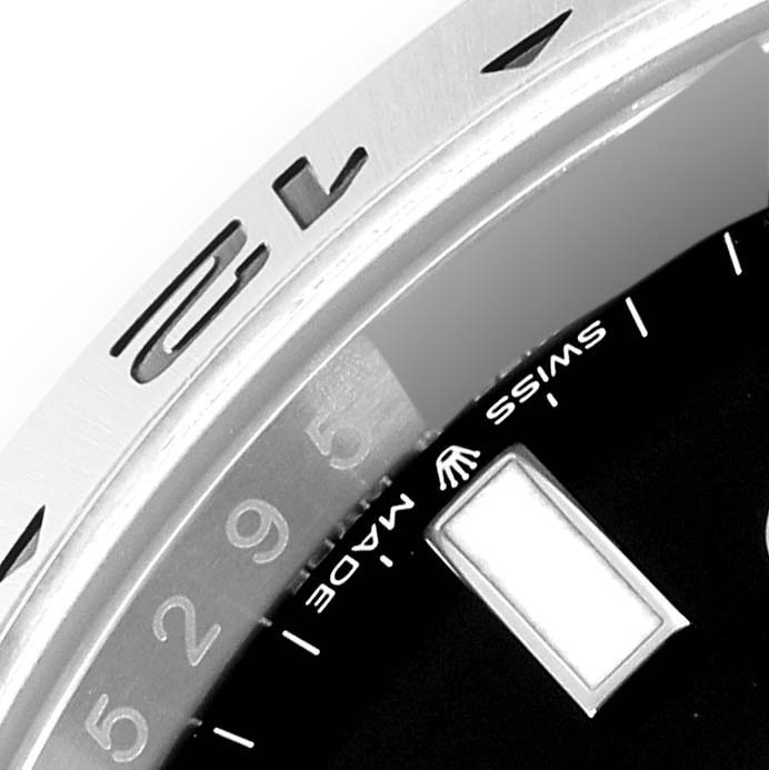 The image shows a close-up of the bezel and part of the dial of a Rolex Explorer M226570-0002 Men's Stainless Steel Black Dial M226570-0002 Men's Stainless Steel Black Dial watch.