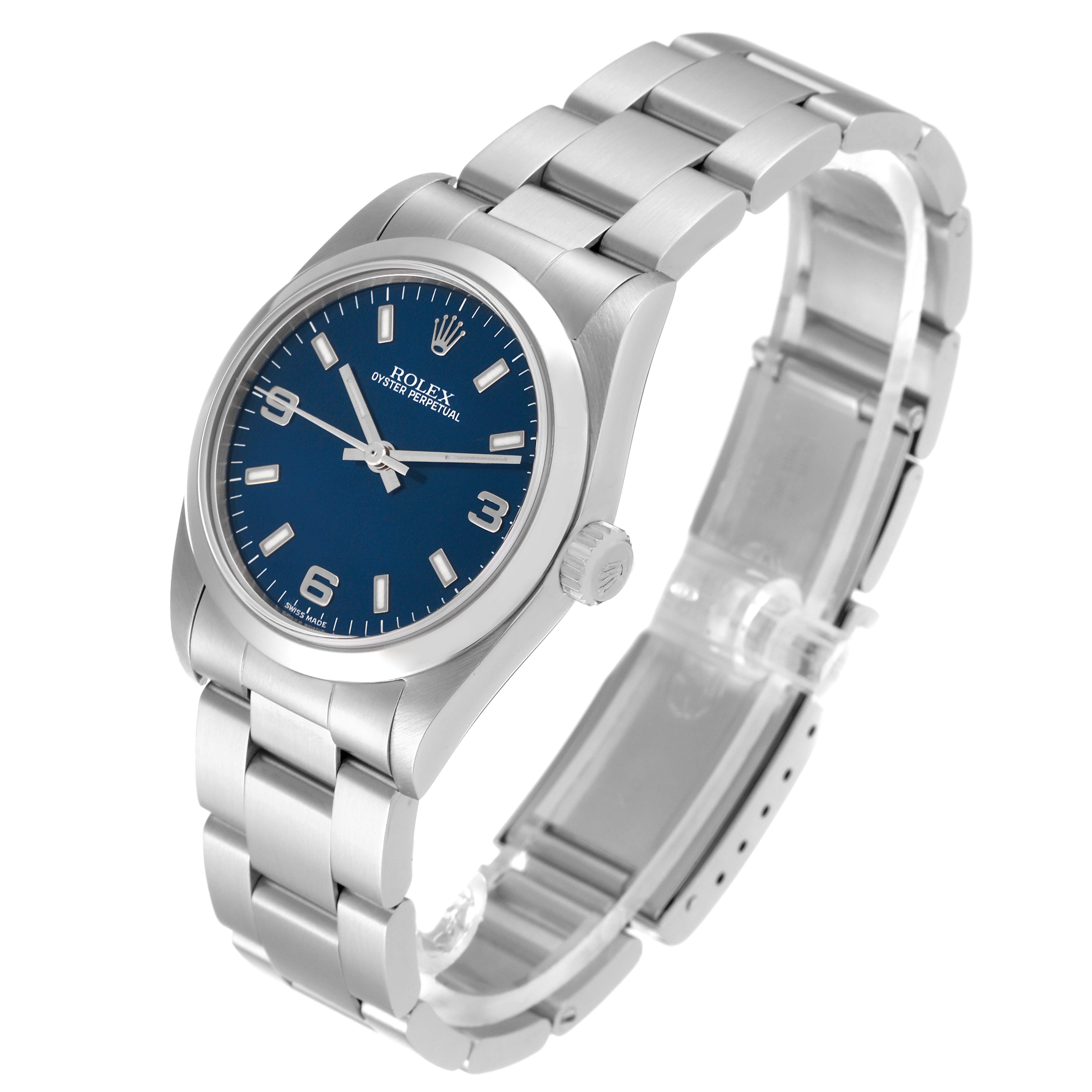 The Rolex Mid-Size 77080 Women
s Stainless Steel Blue Dial 77080 Women
s Stainless Steel Blue Dial watch is shown from a three-quarter angle, displaying its blue dial, crown, and metal bracelet with a clasp.
