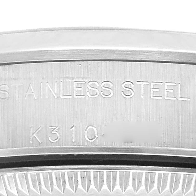 This image shows a close-up of the stainless steel caseback and serial number of a Rolex Oyster Perpetual 76080 Women's Stainless Steel Pink Dial 76080 Women's Stainless Steel Pink Dial watch.