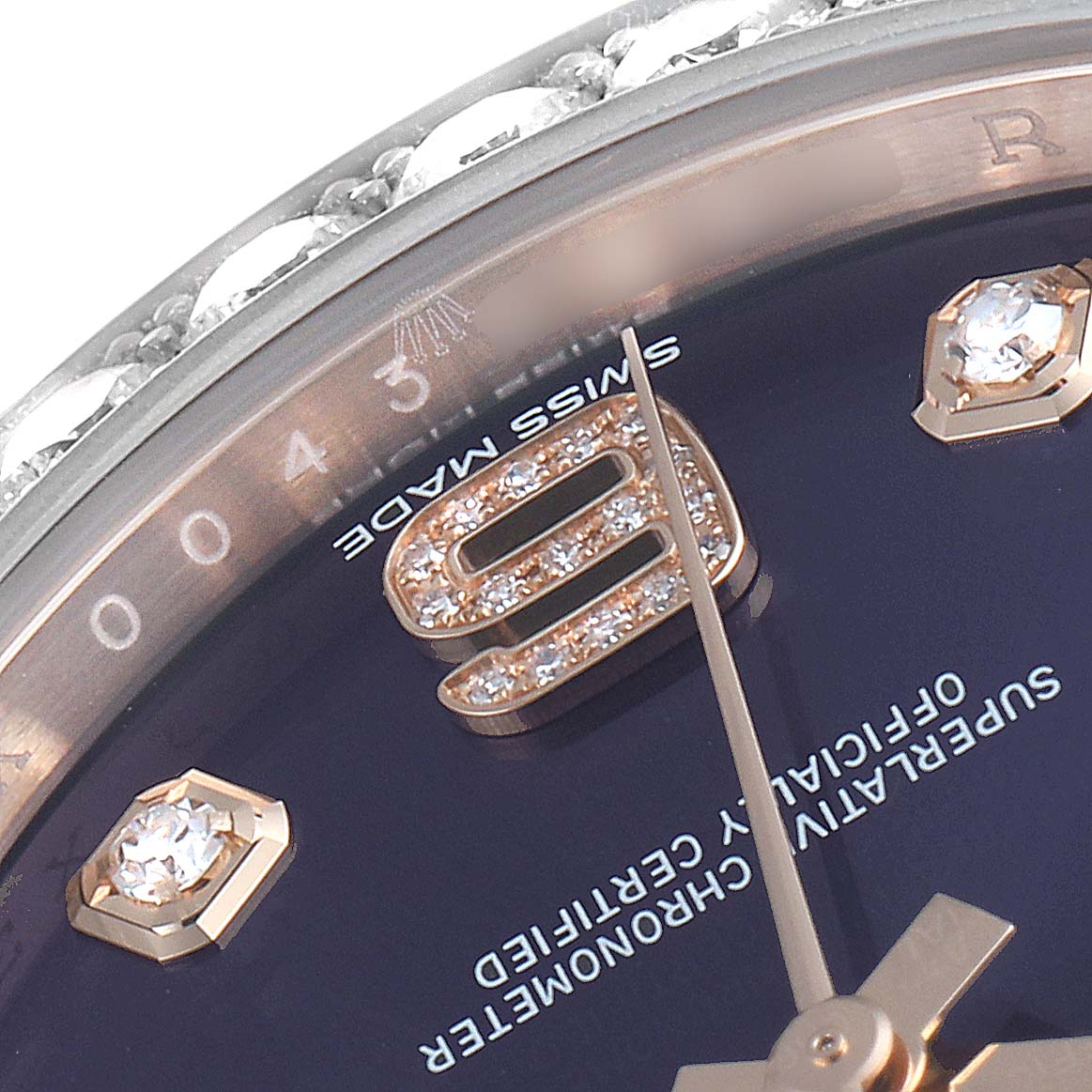 The image shows a close-up of the Rolex Pearlmaster 86285 Men's Rose Gold Blue Dial 86285 Men's Rose Gold Blue Dial watch, highlighting part of the dial, hands, and diamond-studded bezel.