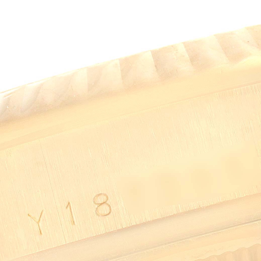 This image shows a close-up angle of the engraved bezel and outer casing of a Rolex President 118238 Men's Yellow Gold Champagne Dial 118238 Men's Yellow Gold Champagne Dial model watch.