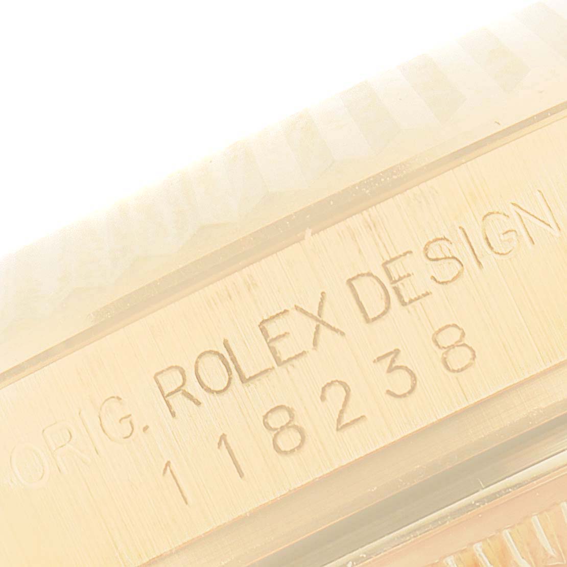 This image shows a close-up of the engraved side of a Rolex President 118238 Men's Yellow Gold Champagne Dial 118238 Men's Yellow Gold Champagne Dial model watch.