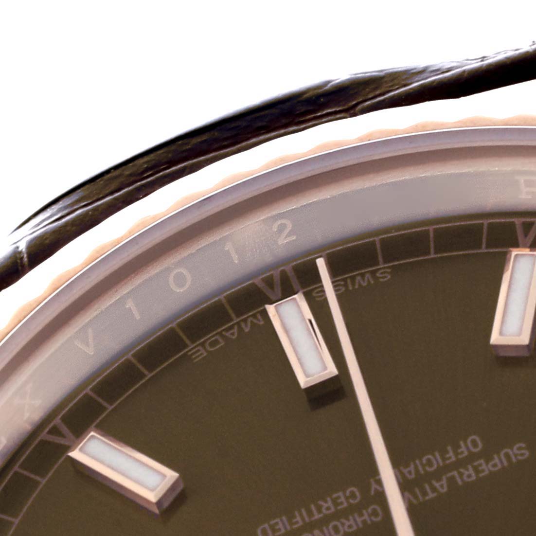 The image shows a close-up of the Rolex President 118135 Men
s Rose Gold Brown Dial 118135 Men
s Rose Gold Brown Dial watch
s dial and indices at an oblique angle.