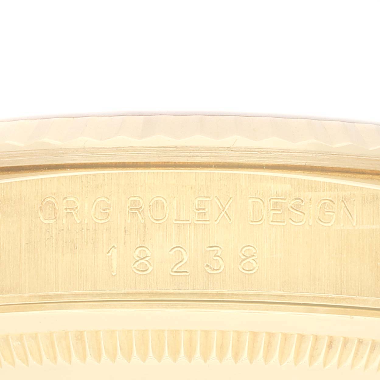 This image shows a close-up of the engraving on the side of a Rolex President 18238 Men's Yellow Gold Champagne Dial 18238 Men's Yellow Gold Champagne Dial model 18238 watch.