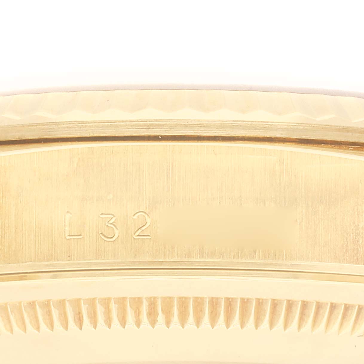 This image shows a close-up of the case back engraving of a Rolex President 18238 Men's Yellow Gold Champagne Dial 18238 Men's Yellow Gold Champagne Dial model watch.
