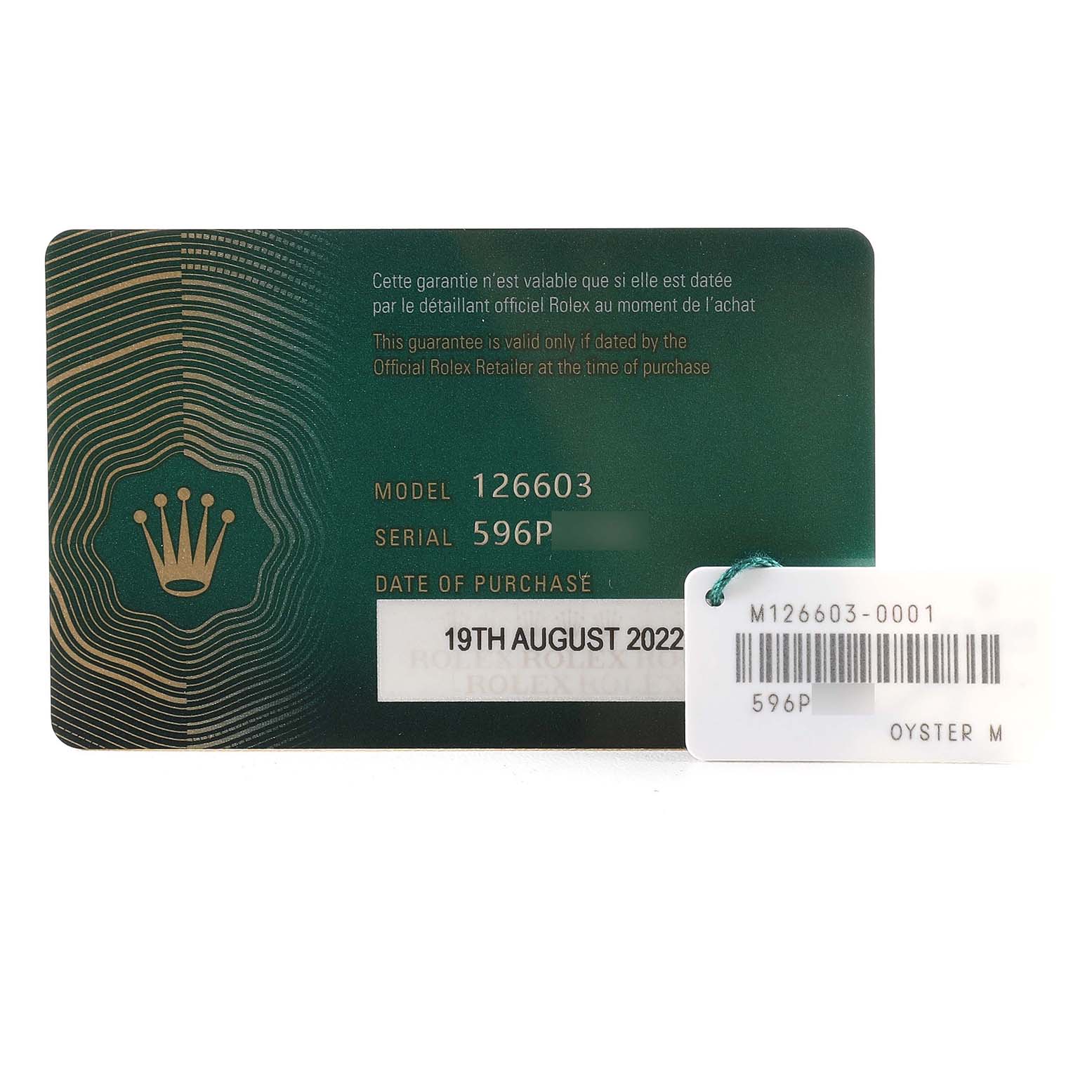 This image shows a warranty card and a barcode tag for a Rolex Sea-Dweller M126603 Men
s Steel and Gold (two tone) Black Dial M126603 Men
s Steel and Gold (two tone) Black Dial model 126603.