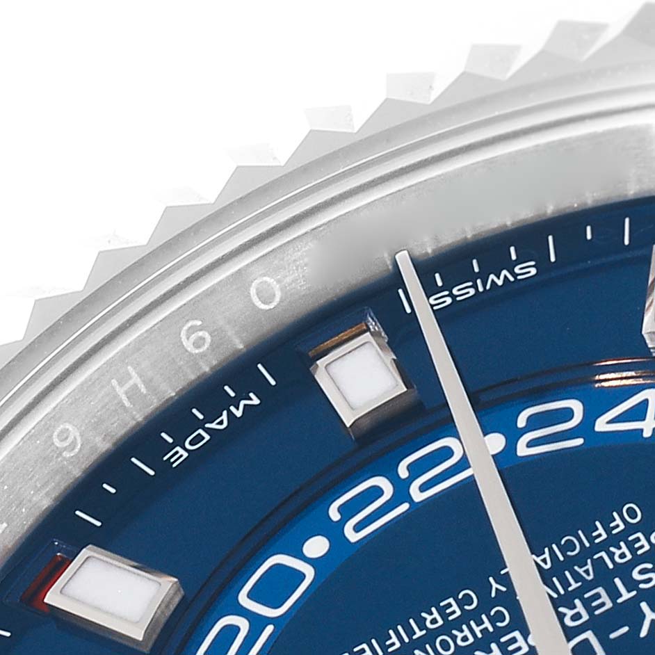The image shows a close-up of the dial, hands, and part of the bezel of a Rolex Sky-Dweller 326934 Men's Stainless Steel Blue Dial 326934 Men's Stainless Steel Blue Dial watch.