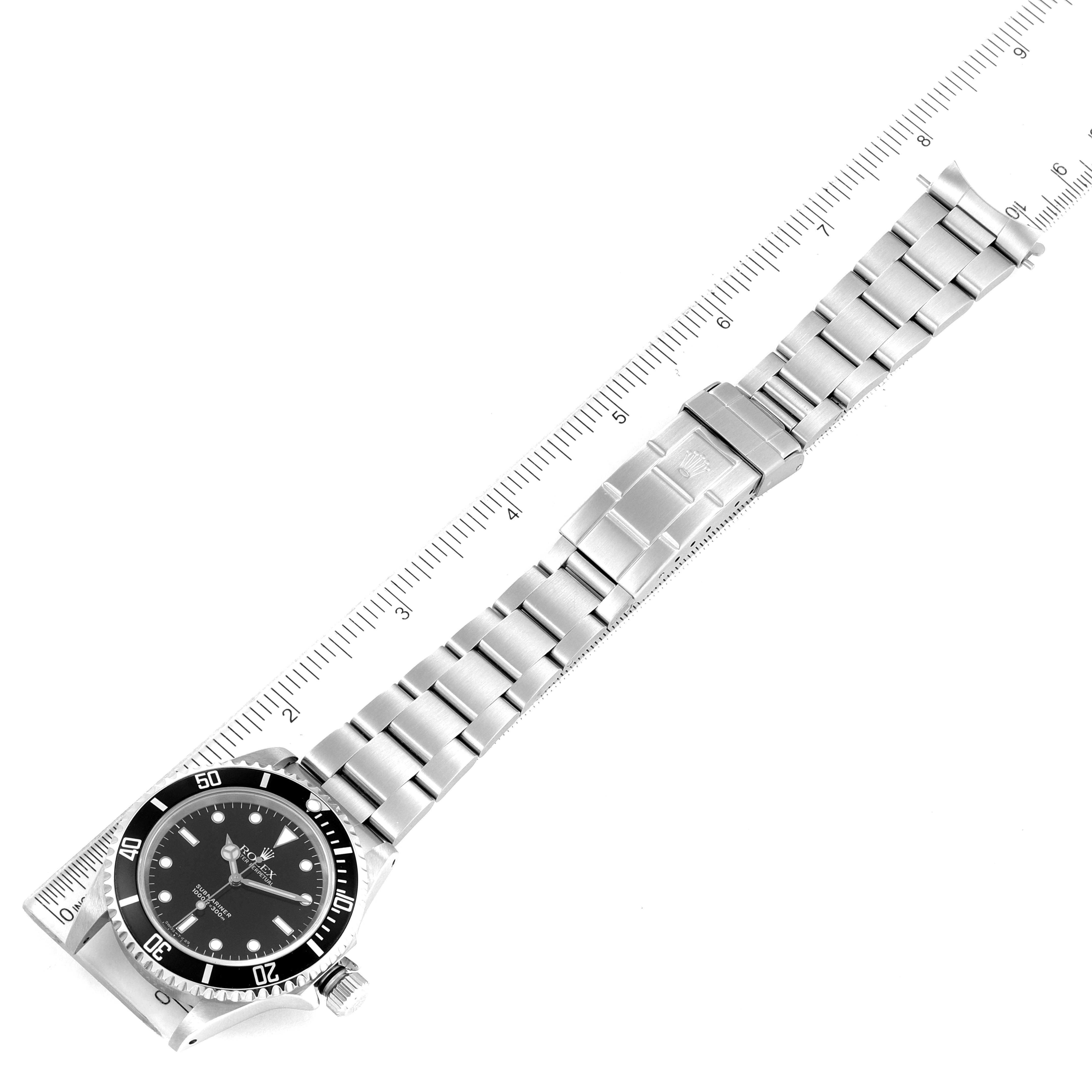 The image shows a top-down view of a Rolex Submariner 14060 Men
s Stainless Steel Black Dial 14060 Men
s Stainless Steel Black Dial watch, highlighting its face, bezel, and bracelet alongside a ruler for measurement.