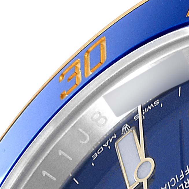 The image shows a close-up of the bezel and part of the watch face of a Rolex Submariner 126613 Men's Steel and Gold (two tone) Blue Dial 126613 Men's Steel and Gold (two tone) Blue Dial, highlighting the 30-minute marker.