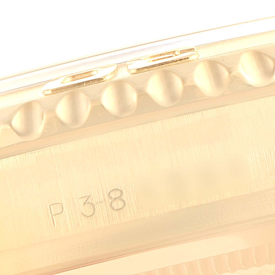 This close-up image shows the engraved bezel and case side of the Rolex Yacht-Master 16628 Men's Yellow Gold White Dial 16628 Men's Yellow Gold White Dial watch.