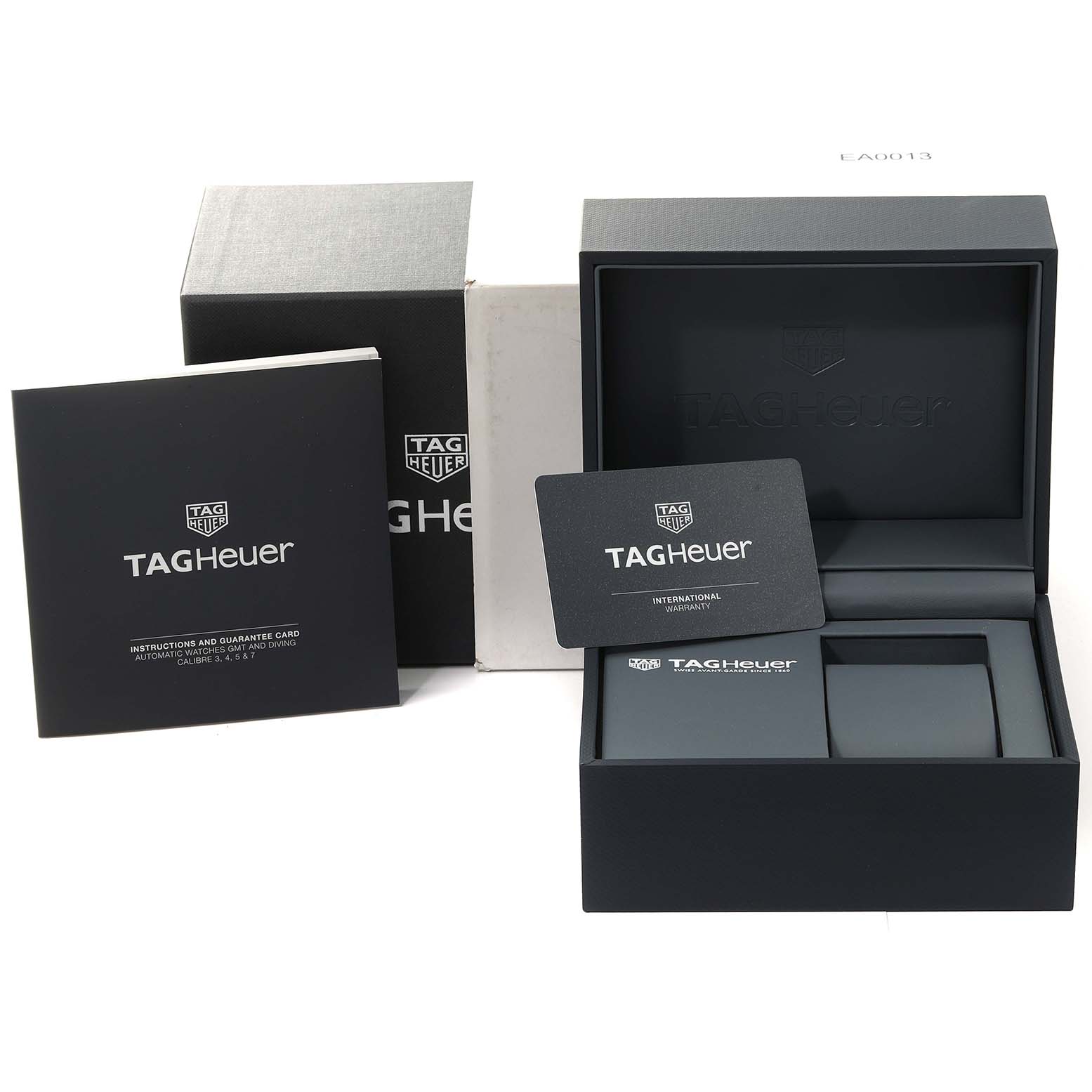 The image shows the packaging, instruction manual, guarantee card, and warranty card for a Tag Heuer Aquaracer WAY211A Men's Stainless Steel Black Dial WAY211A Men's Stainless Steel Black Dial watch.