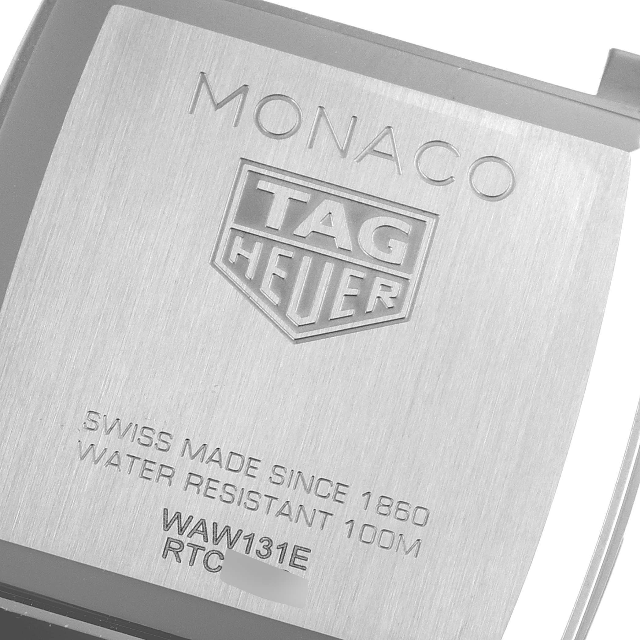 The image shows the case back of the Tag Heuer Monaco WAW131E.FC6420 Men's Stainless Steel Brown Dial WAW131E.FC6420 Men's Stainless Steel Brown Dial watch, featuring engravings of the brand, model, and specifications.