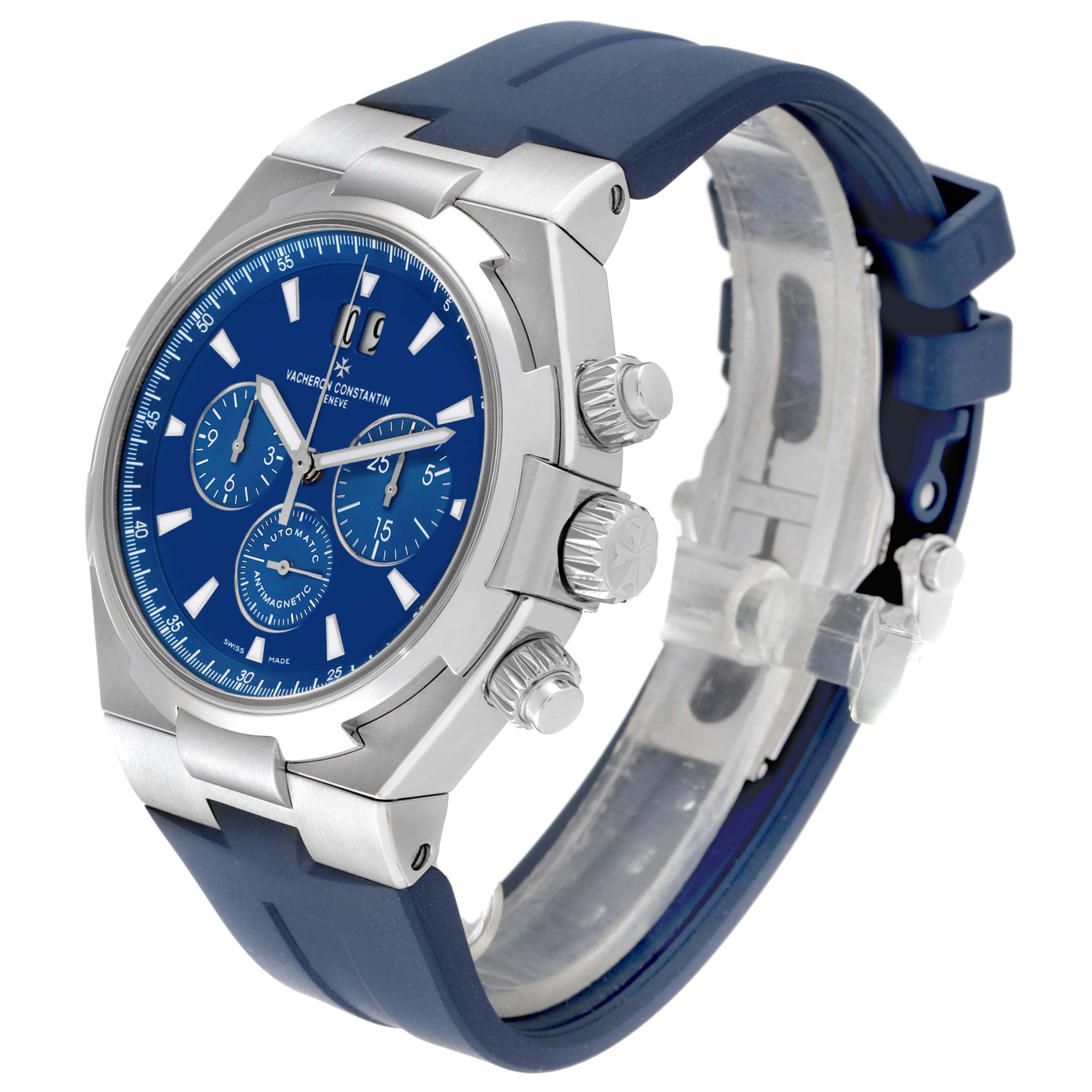 The Vacheron Constantin Overseas 49150/000A-9745 Men's Stainless Steel Blue Dial watch is shown at a three-quarter angle, highlighting its blue dial, side buttons, and rubber strap.
