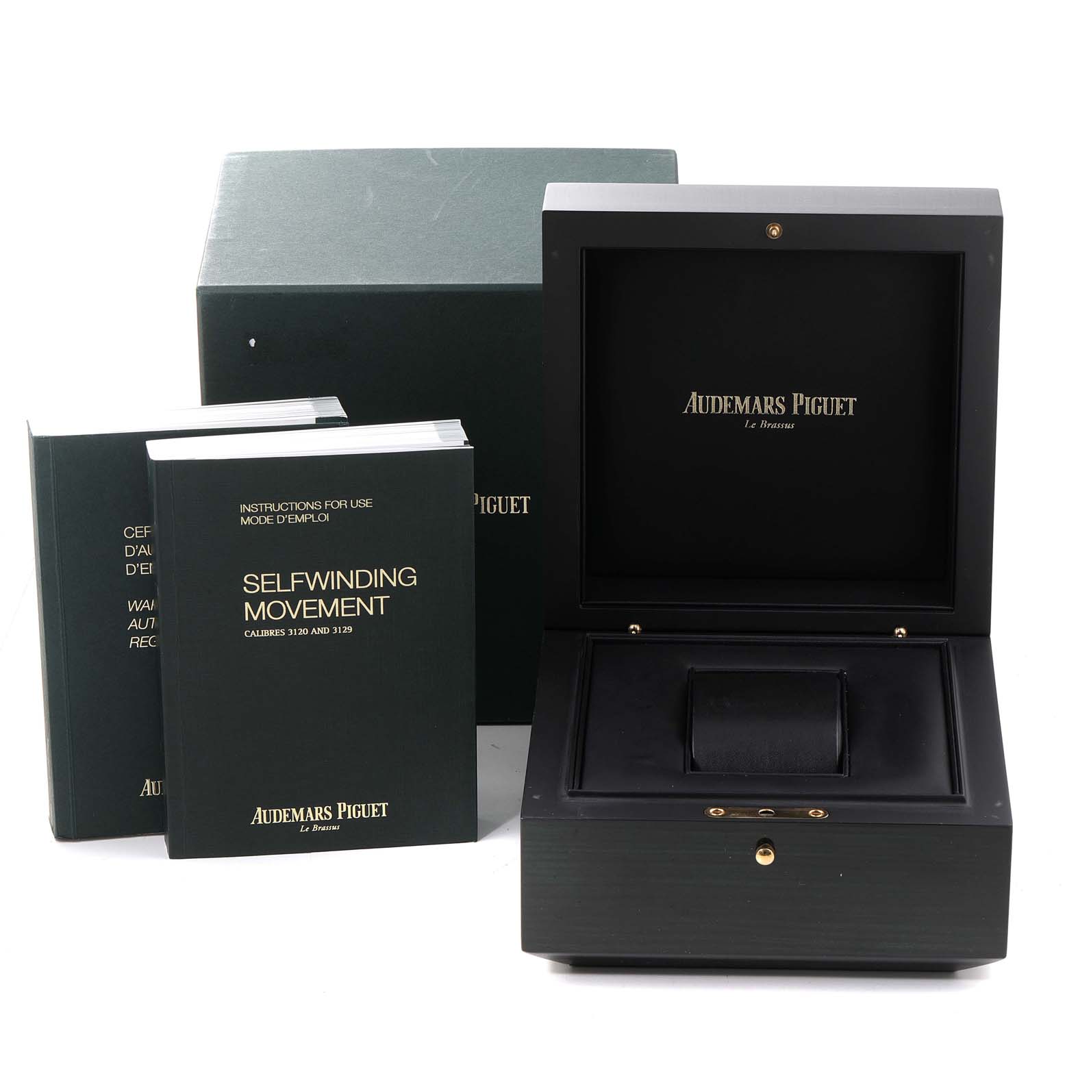 The image shows the packaging and manuals for the Audemars Piguet Royal Oak 15450ST.OO.1256ST.01 Men's Stainless Steel Silver Dial 15450ST.OO.1256ST.01 Men's Stainless Steel Silver Dial, including an open watch box and instruction booklets.