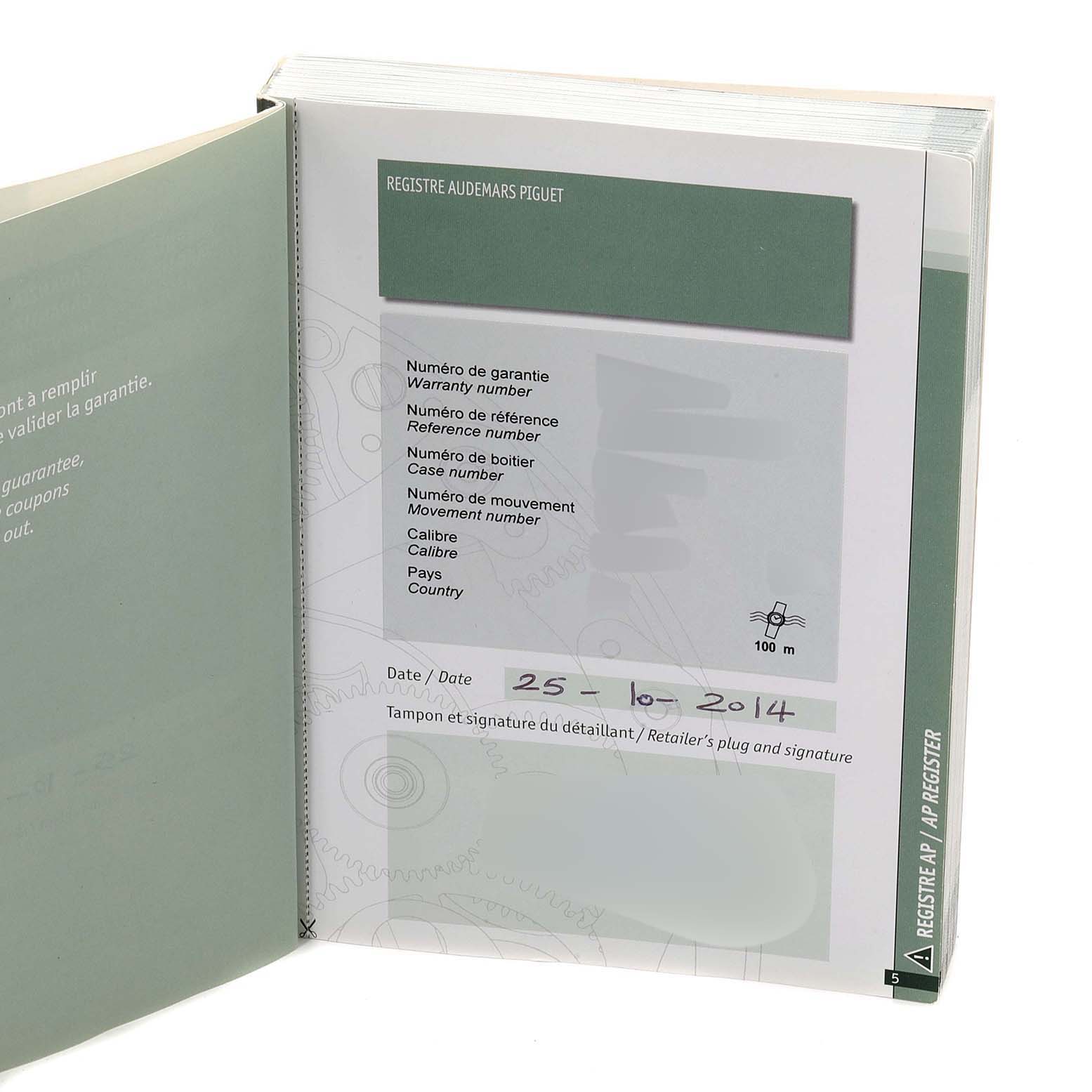 This image shows an open warranty booklet for the Audemars Piguet Royal Oak Offshore 26202AU.OO.D002CA.01 Men's Stainless Steel Grey Dial 26202AU.OO.D002CA.01 Men's Stainless Steel Grey Dial model, displaying warranty details and a date.