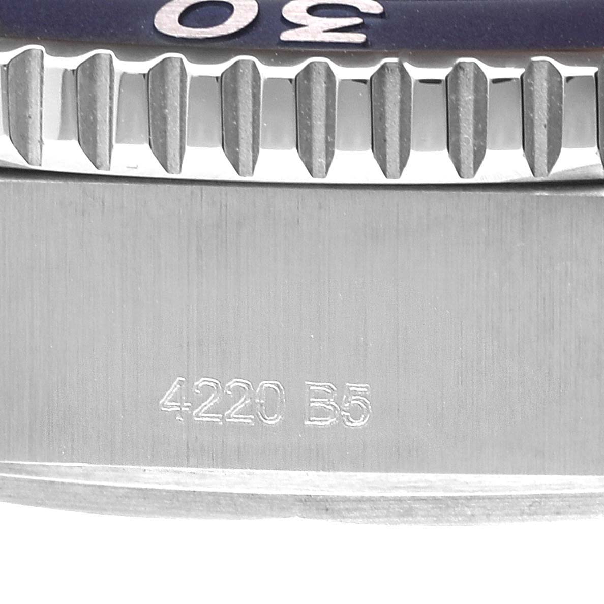 This image shows a close-up of the bezel and case side of a Breitling Superocean A17367 Men's Stainless Steel Blue Dial A17367 Men's Stainless Steel Blue Dial watch, including engraved markings.