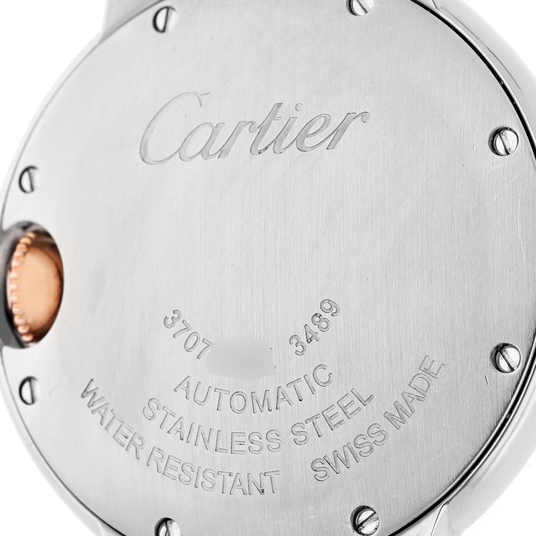 The image shows the back of a Cartier Ballon Bleu WE902044 Women's Stainless Steel Silver Dial watch, featuring engraved details and part of the crown.