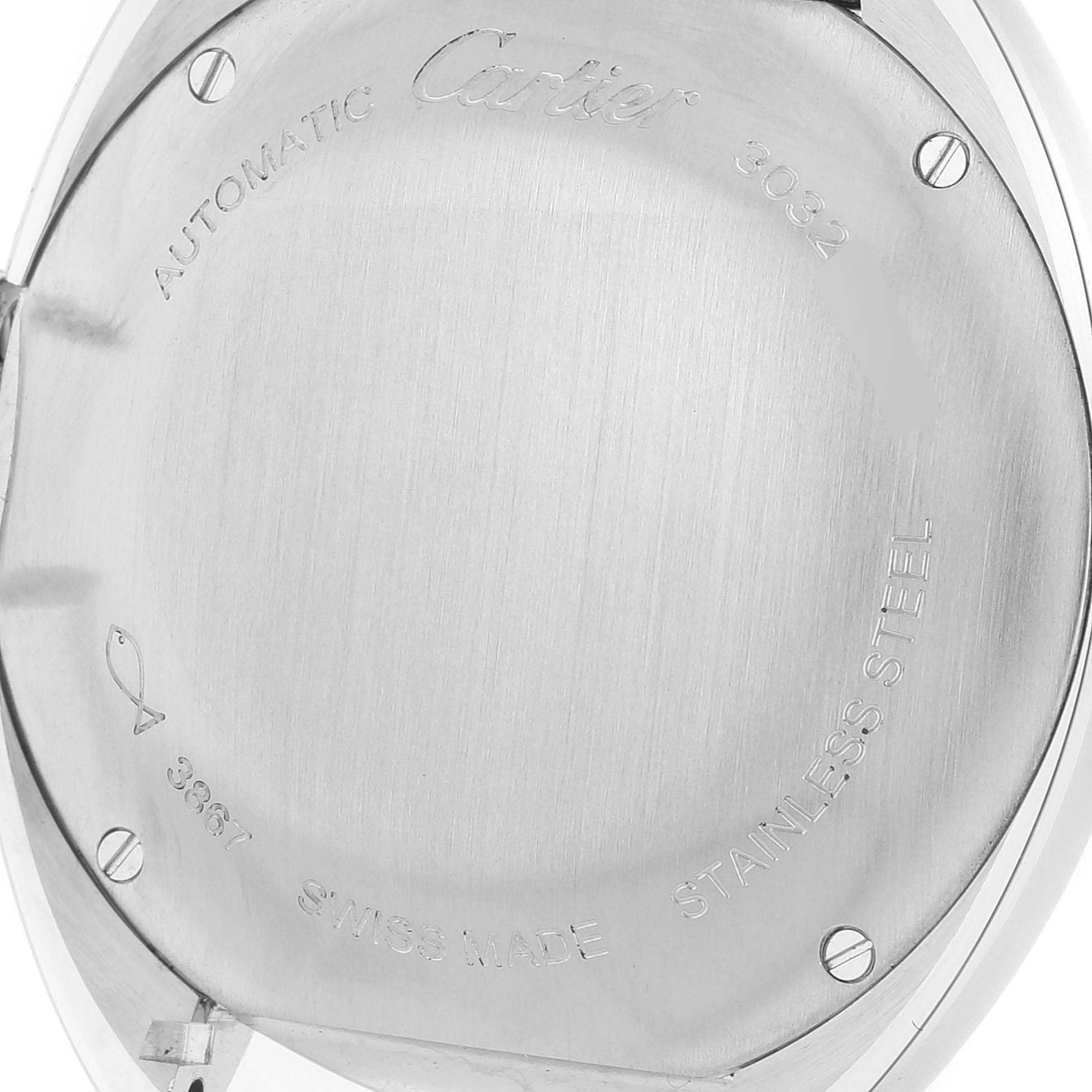 The image shows the back case of a Cle model watch by Cartier, focusing on its engravings and brushed stainless steel surface.