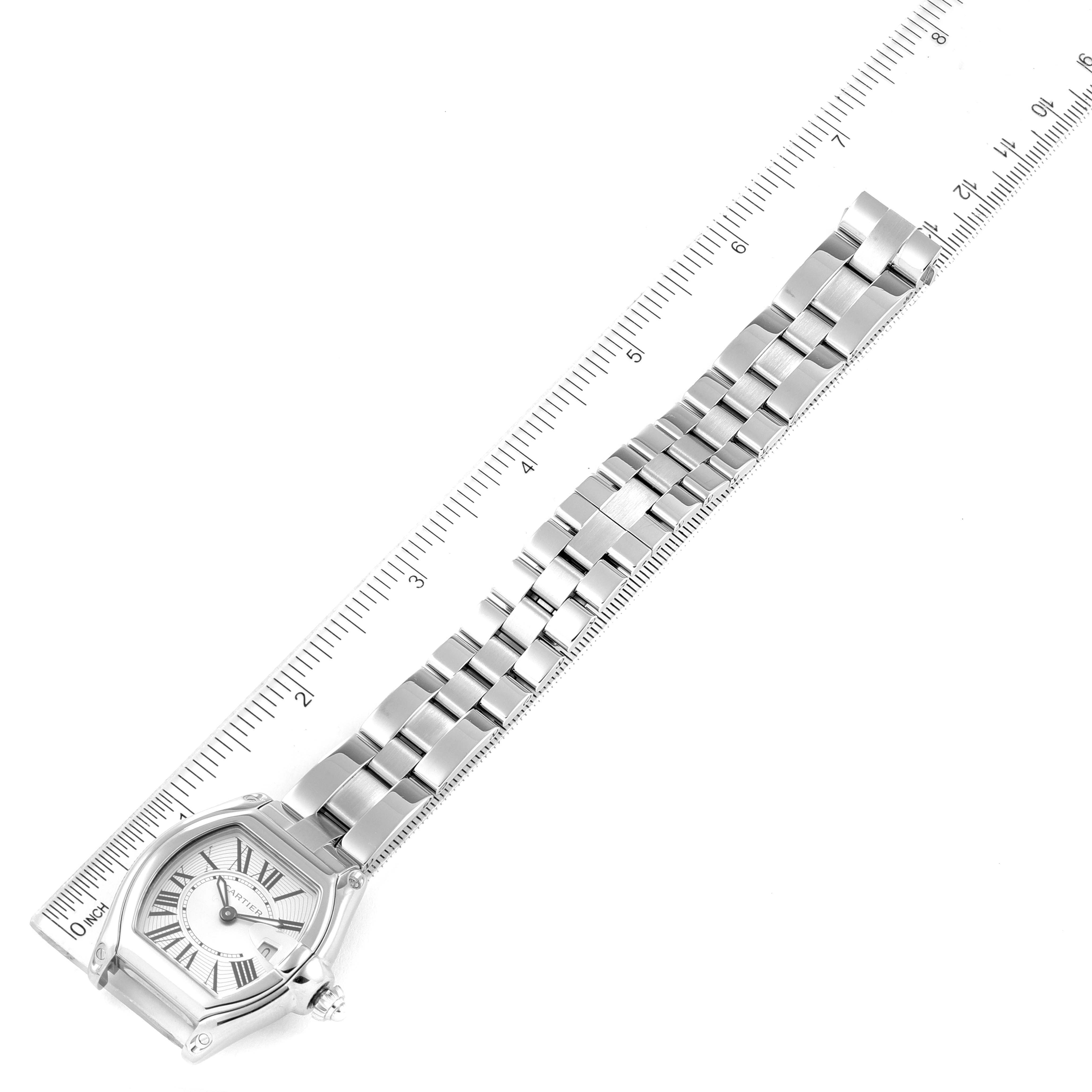 The Cartier Roadster W62016V3 Women's Stainless Steel Silver Dial W62016V3 Women's Stainless Steel Silver Dial watch is shown at a top-down angle, highlighting the face, bracelet, and a ruler for measurement.