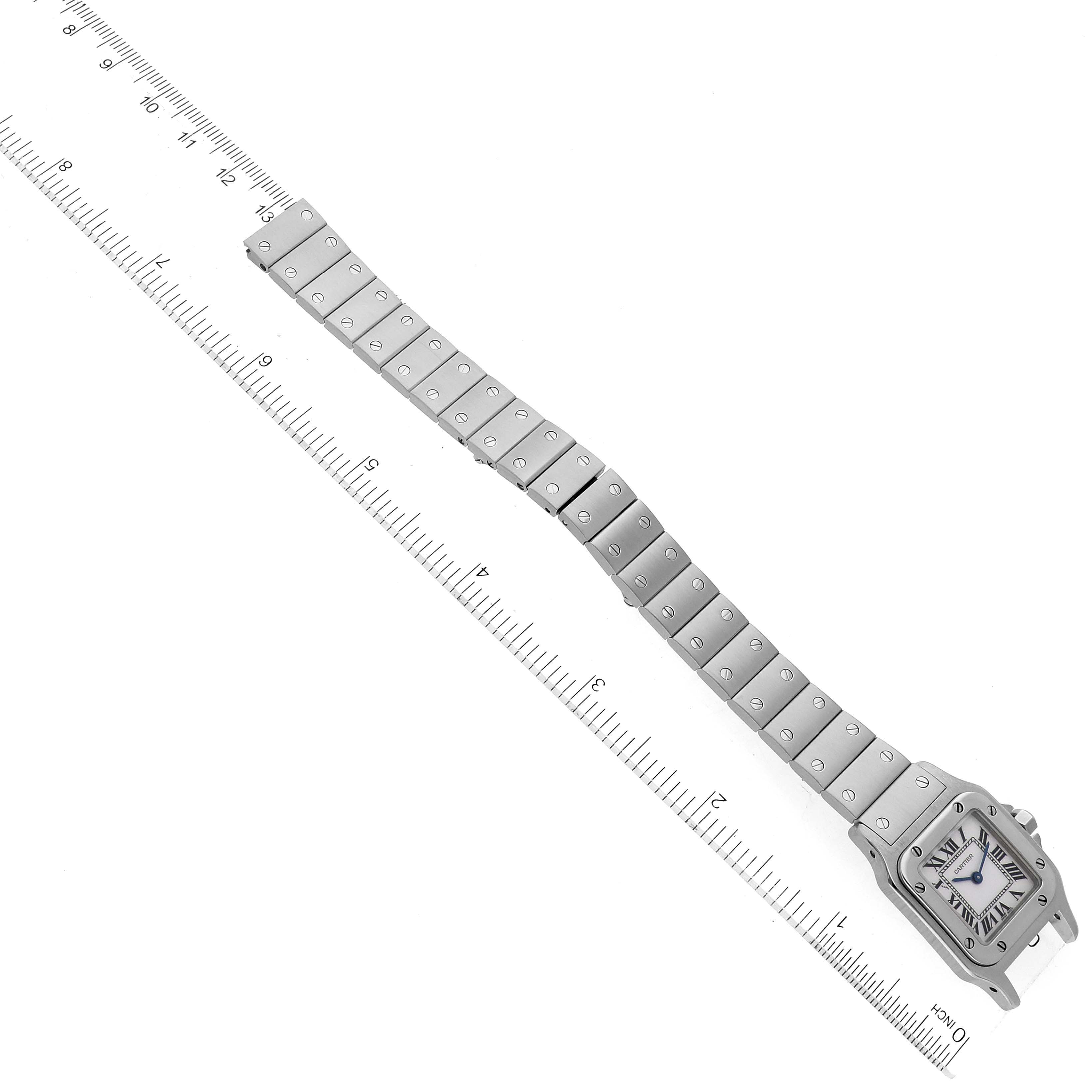 The image shows a Cartier Santos W20056D6 Women's Stainless Steel Silver Dial W20056D6 Women's Stainless Steel Silver Dial watch displayed flat with the entire bracelet extended and a ruler next to it.