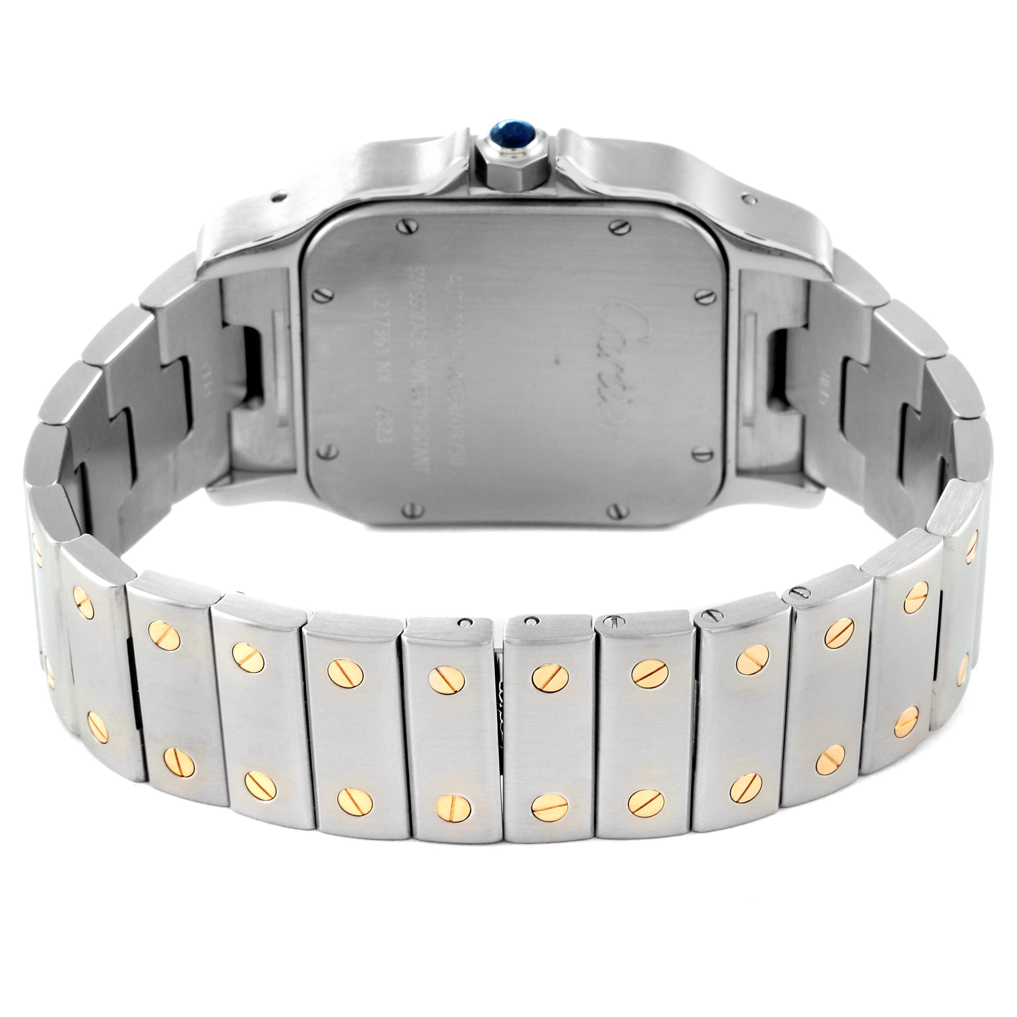 The image shows the back case and metal bracelet of a Cartier Santos W20099C4 Men's Steel and Gold (two tone) Silver Dial W20099C4 Men's Steel and Gold (two tone) Silver Dial watch, featuring screw detail and a blue cabochon crown.