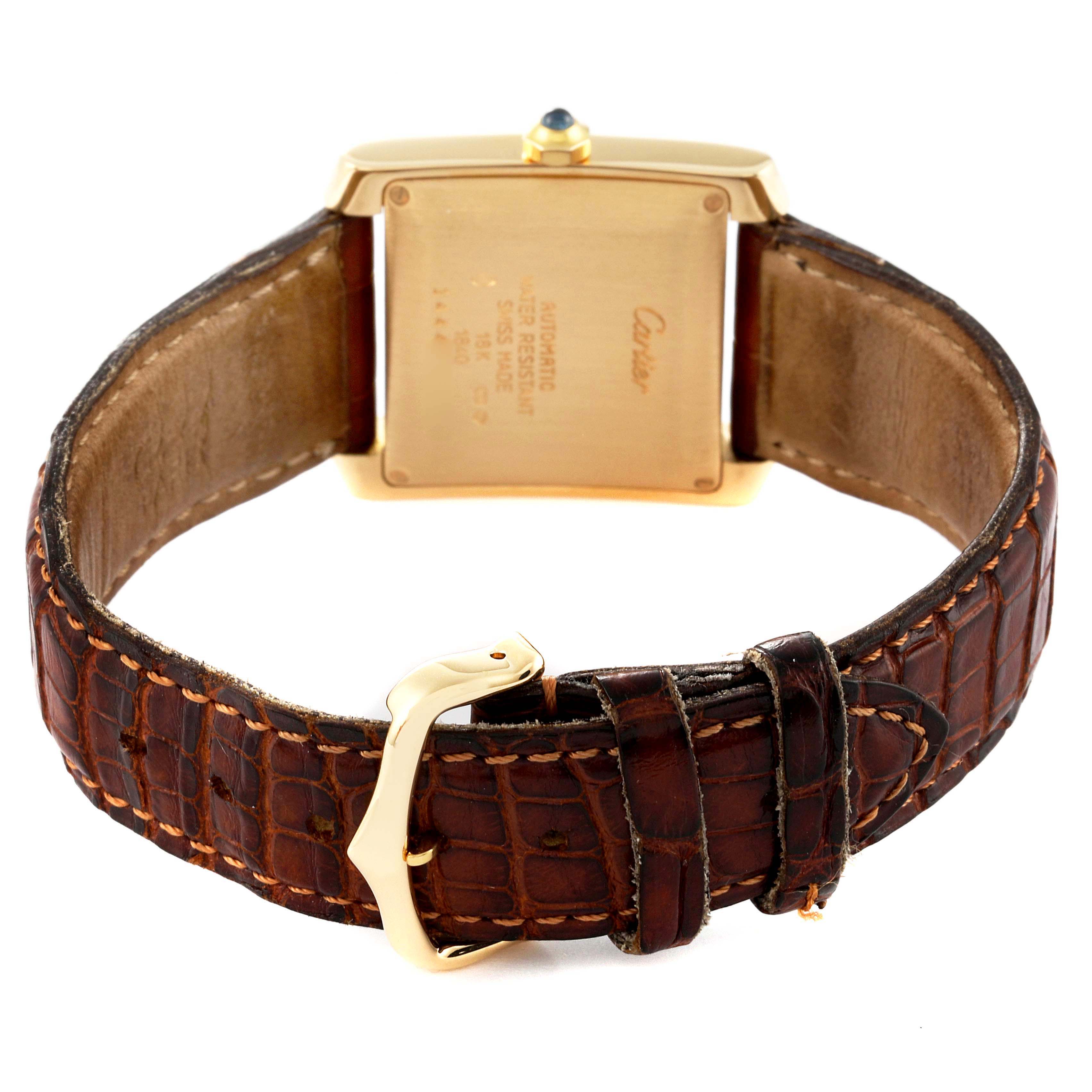 The image shows the back case and leather strap of a Cartier Tank Française watch.