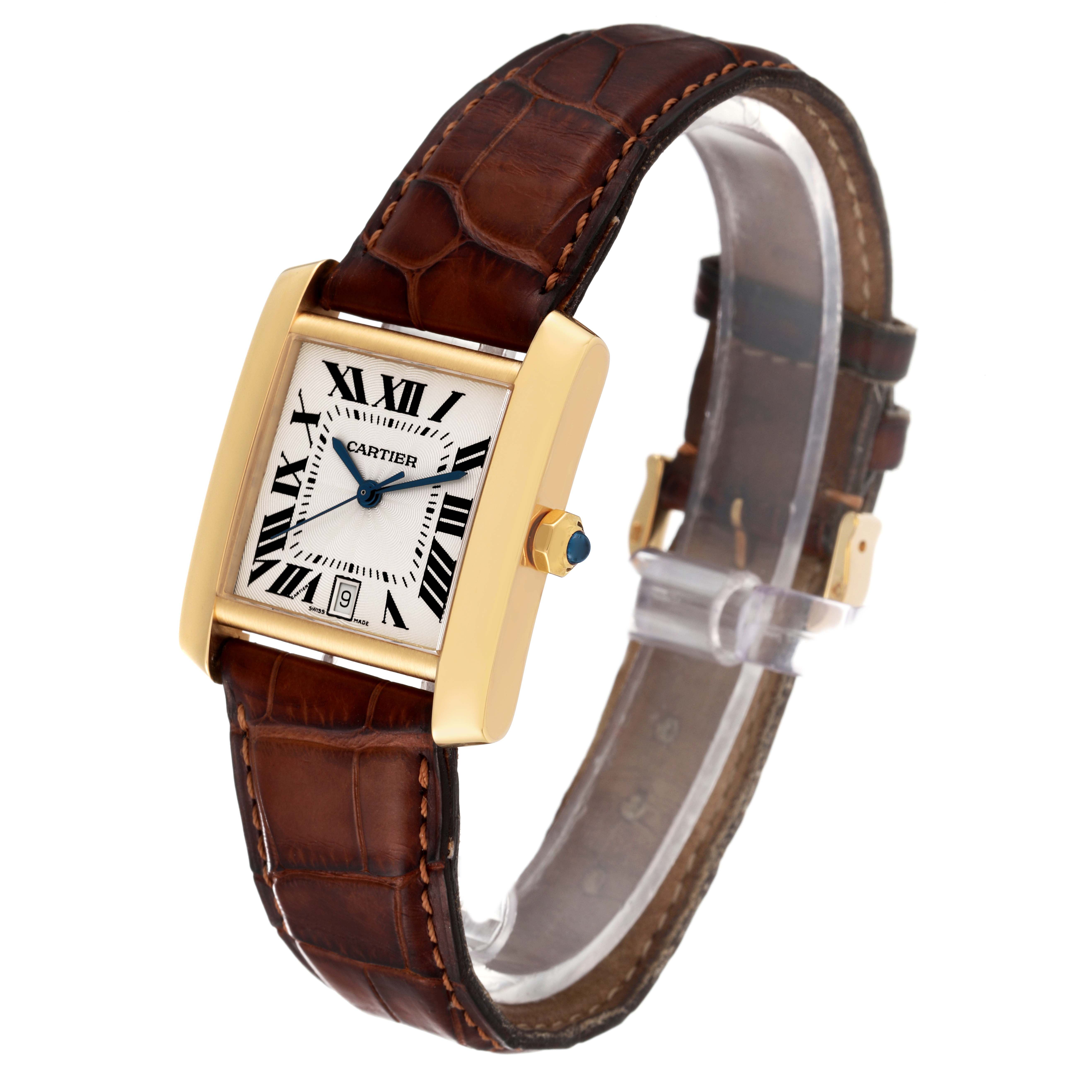 This image shows a Cartier Tank Francaise W5000156 Men's Yellow Gold Silver Dial W5000156 Men's Yellow Gold Silver Dial watch at a three-quarter angle, highlighting its face, brown leather strap, and gold casing.