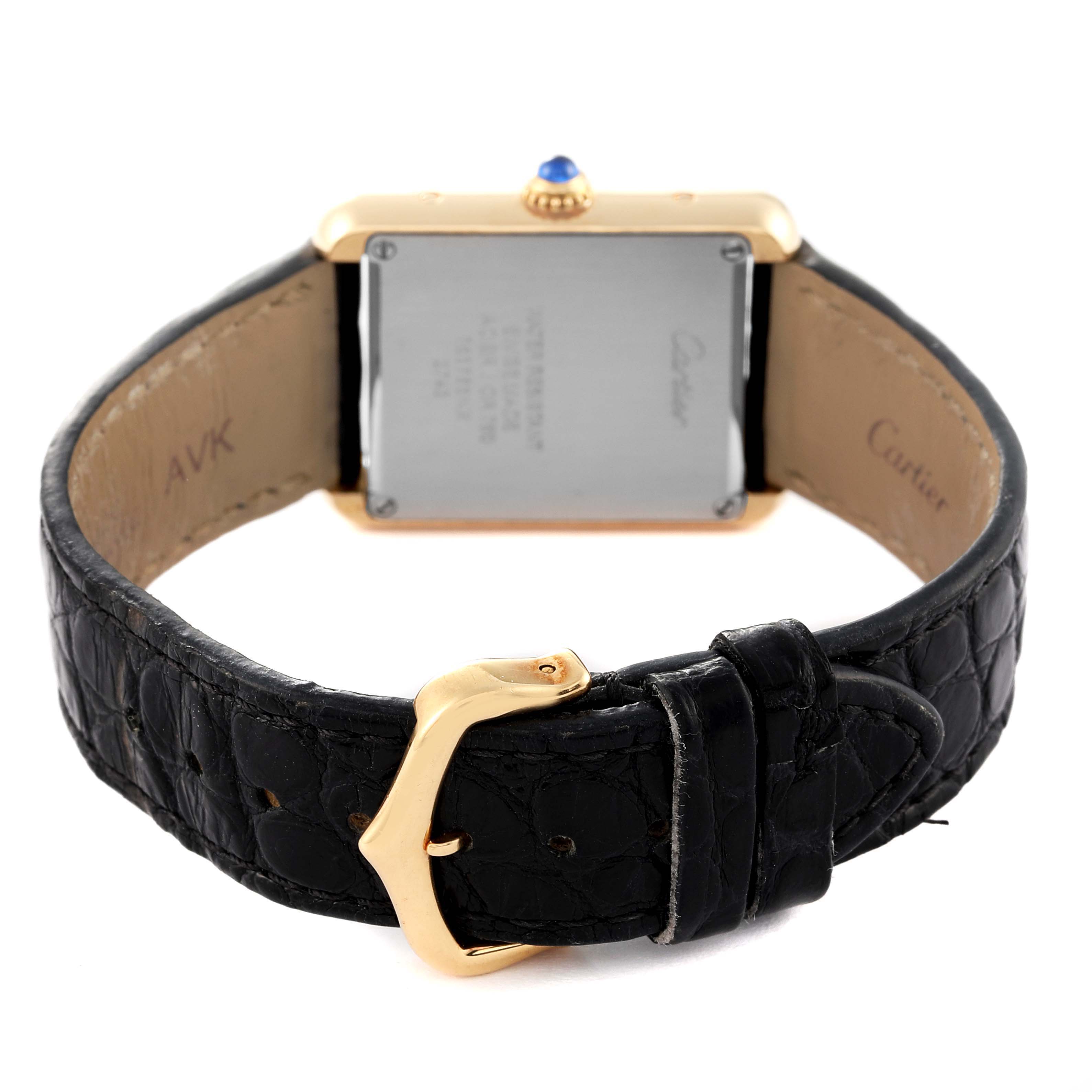 This image shows the back and clasp of the Cartier Tank Solo W1018755 Women's Yellow Gold Silver Dial W1018755 Women's Yellow Gold Silver Dial watch, highlighting its leather strap and the case back details.